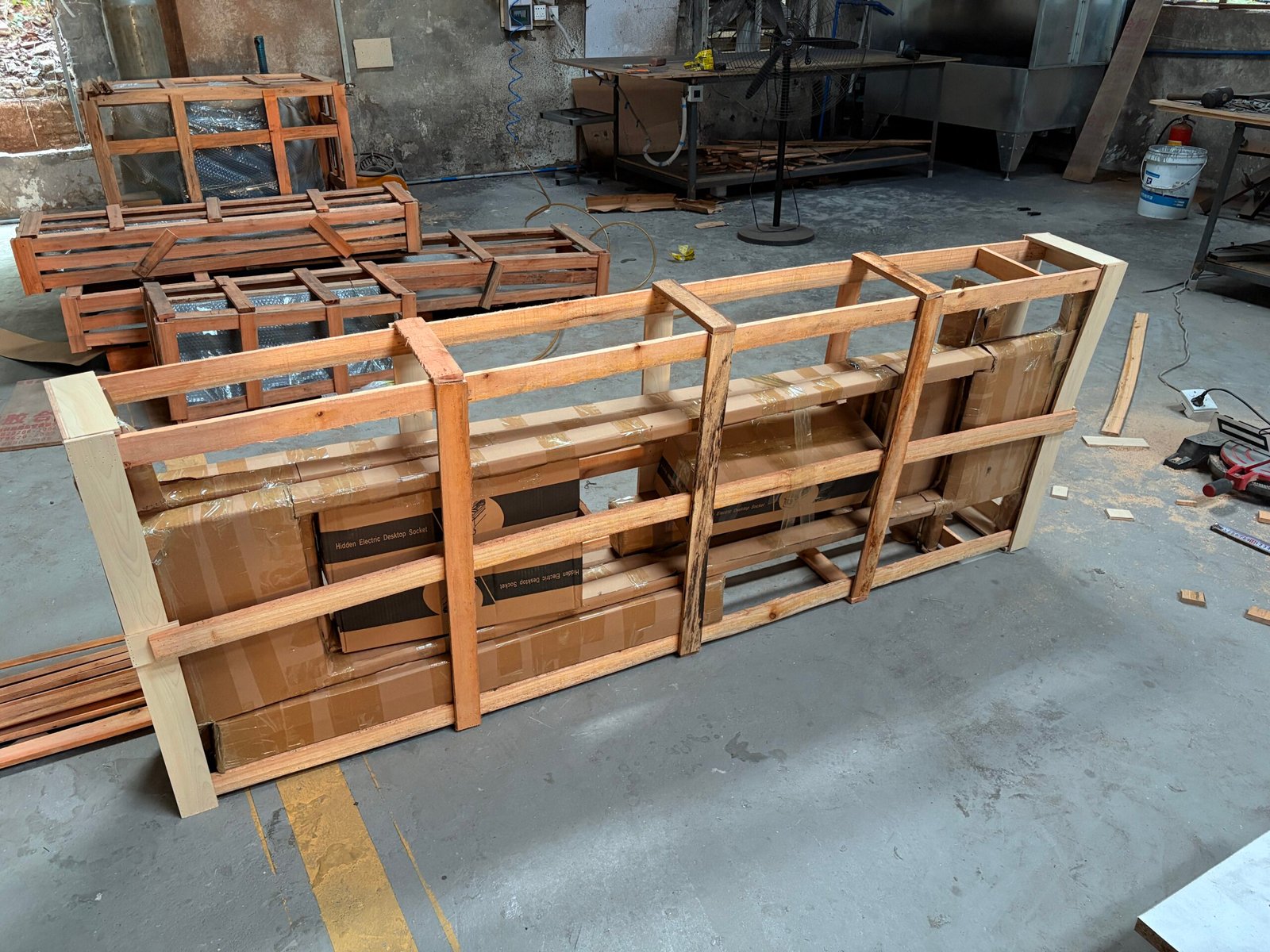 Office furniture protected by timber framing for transport