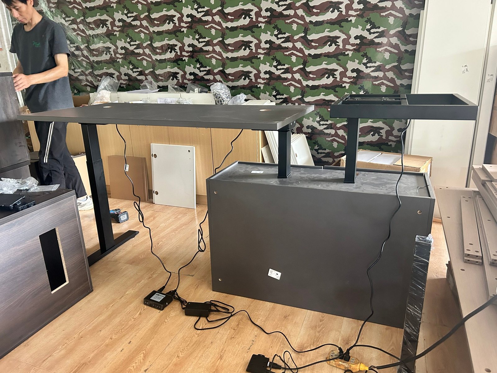 Desk frame and desktop components being checked during trial assembly