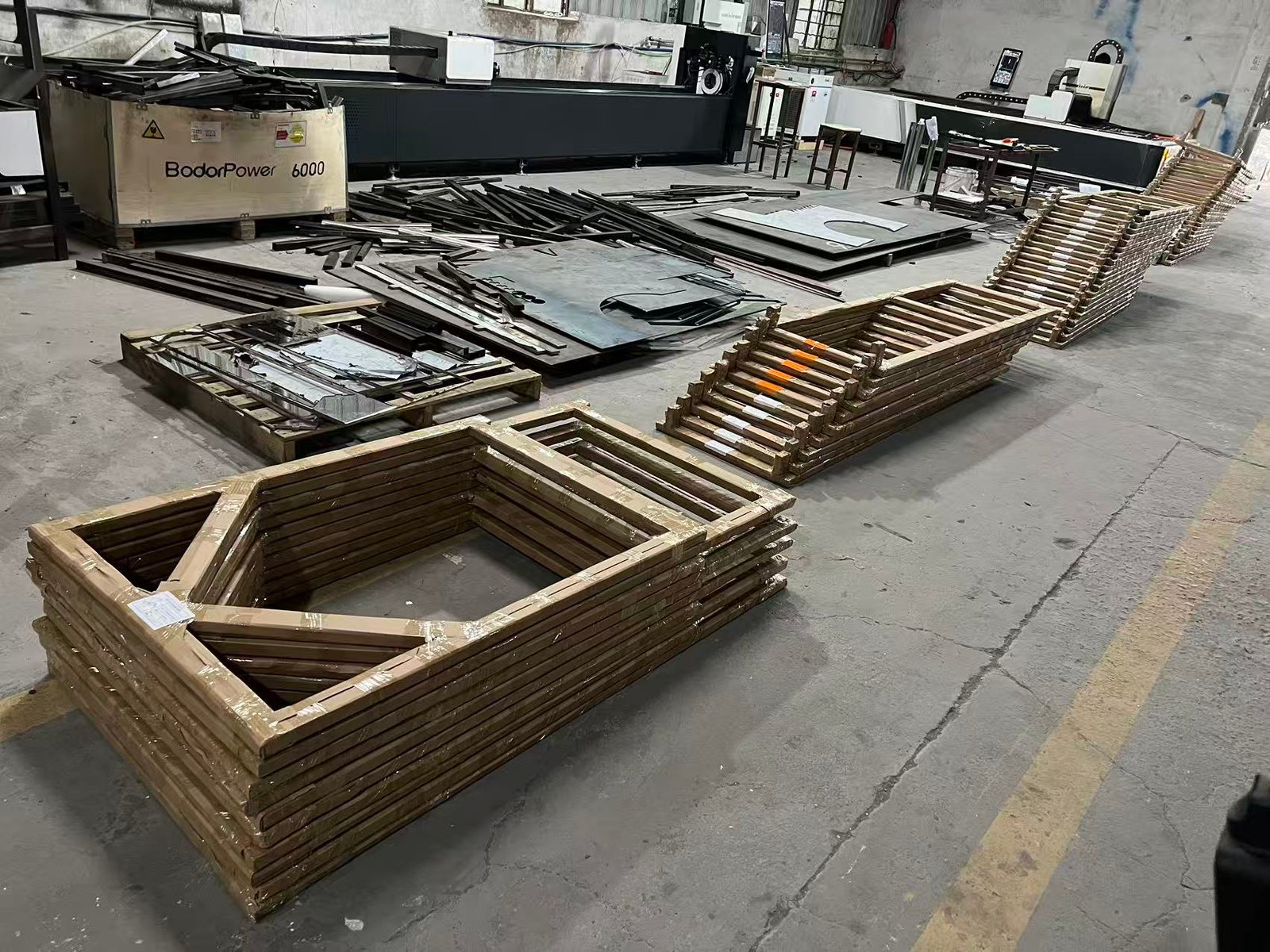 Furniture components and frames organised on the NORDA workshop floor